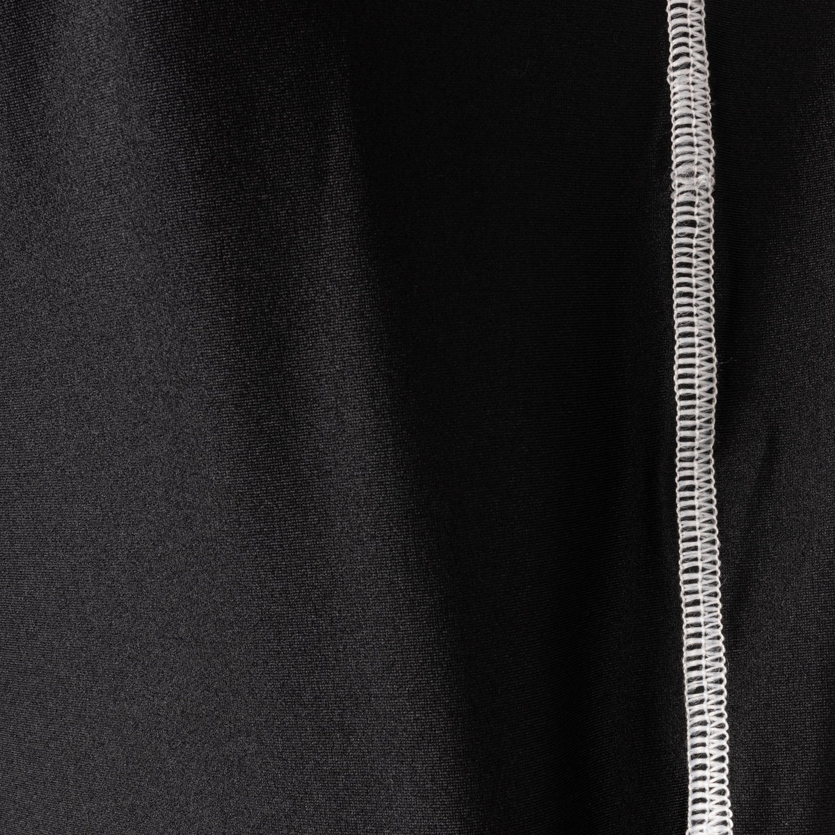 Golf Swing Shirt close-up of patented compression fabric with swing plane guide panels and Golf Swing Shirt logo detailed stitch